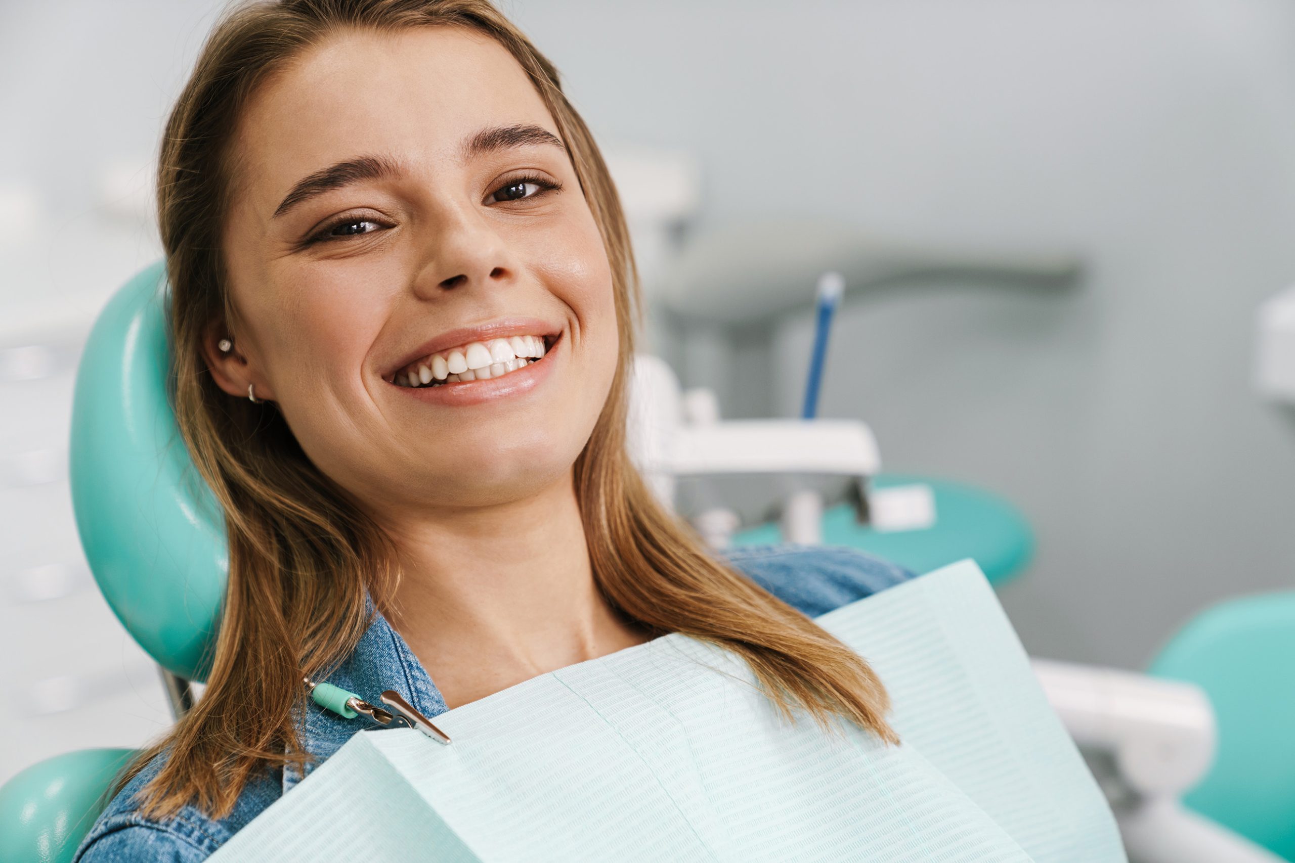 woman smiling at dentist - Midway Dental Group